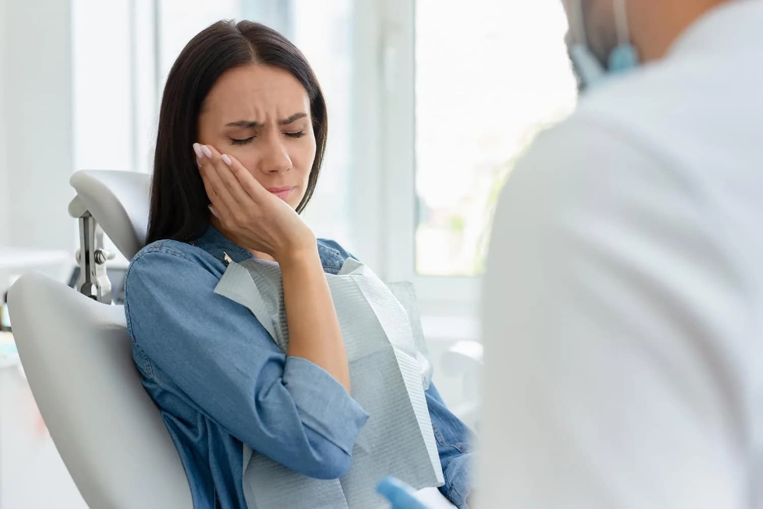 Dental patient experiencing discomfort at Neola Dental in Minneola, FL.