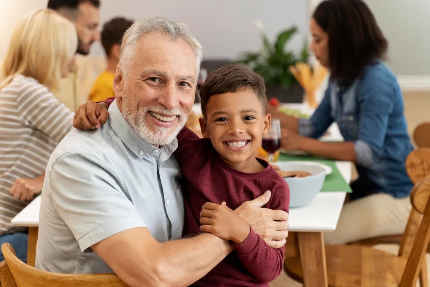 Happy grandfather with grandson at family gatherin