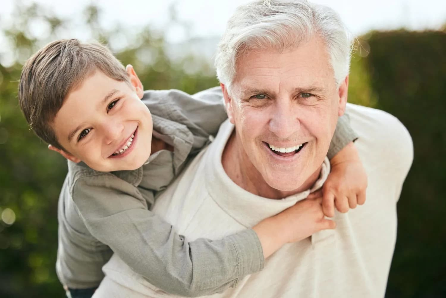 Happy grandfather and grandson enjoying outdoor time together