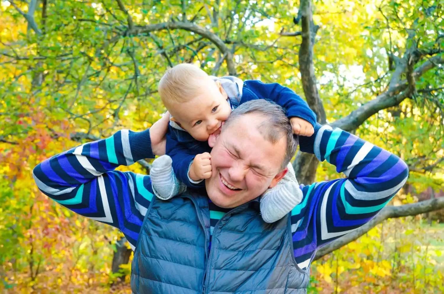 Happy father and son enjoying fall outdoors