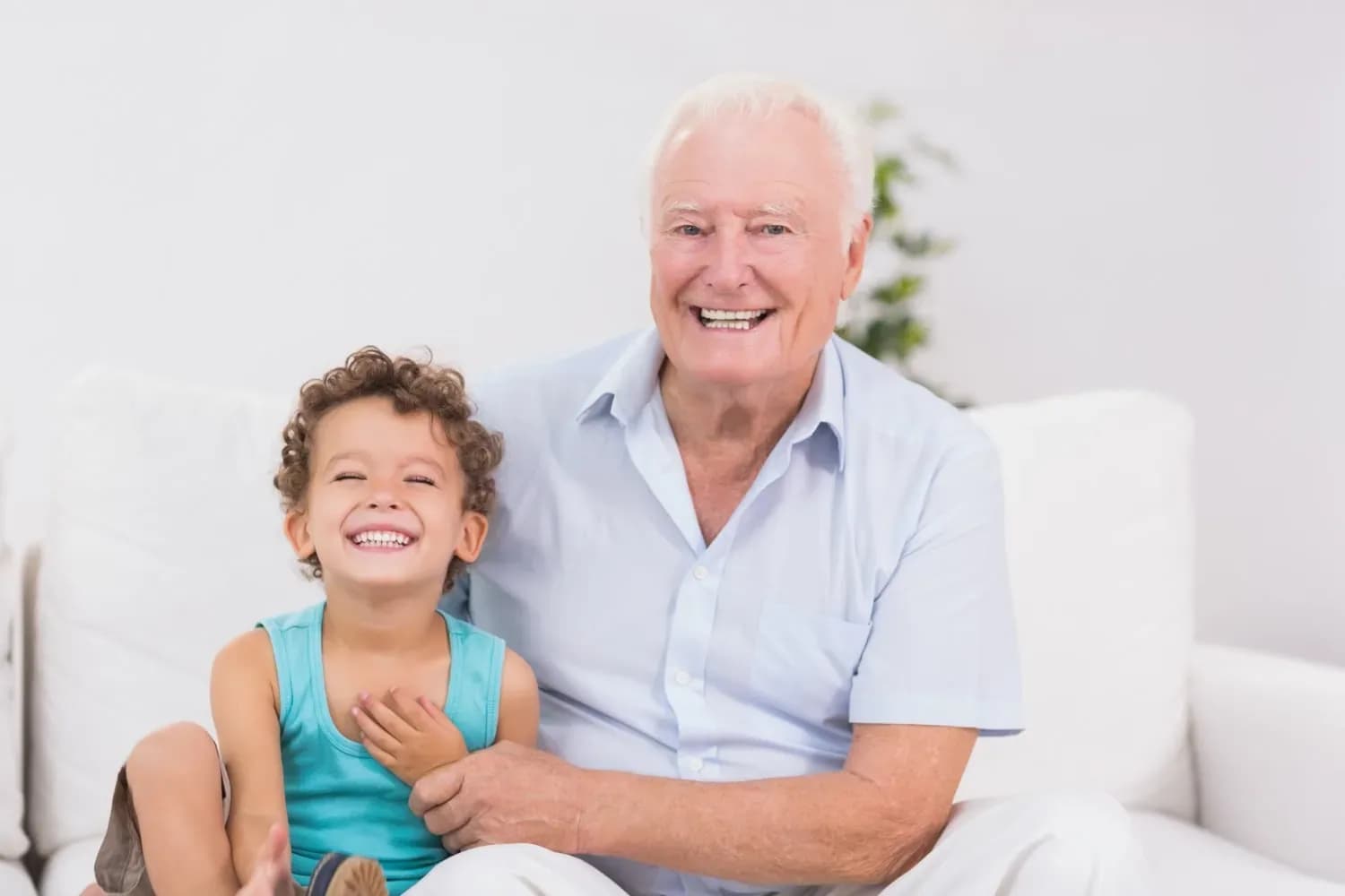 Happy grandfather with granddaughter at home