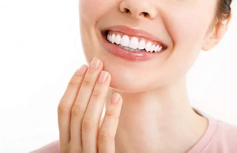 Woman with a healthy, flawless white smile - porcelain veneers and dental crowns at Neola Dental in Minneola, FL