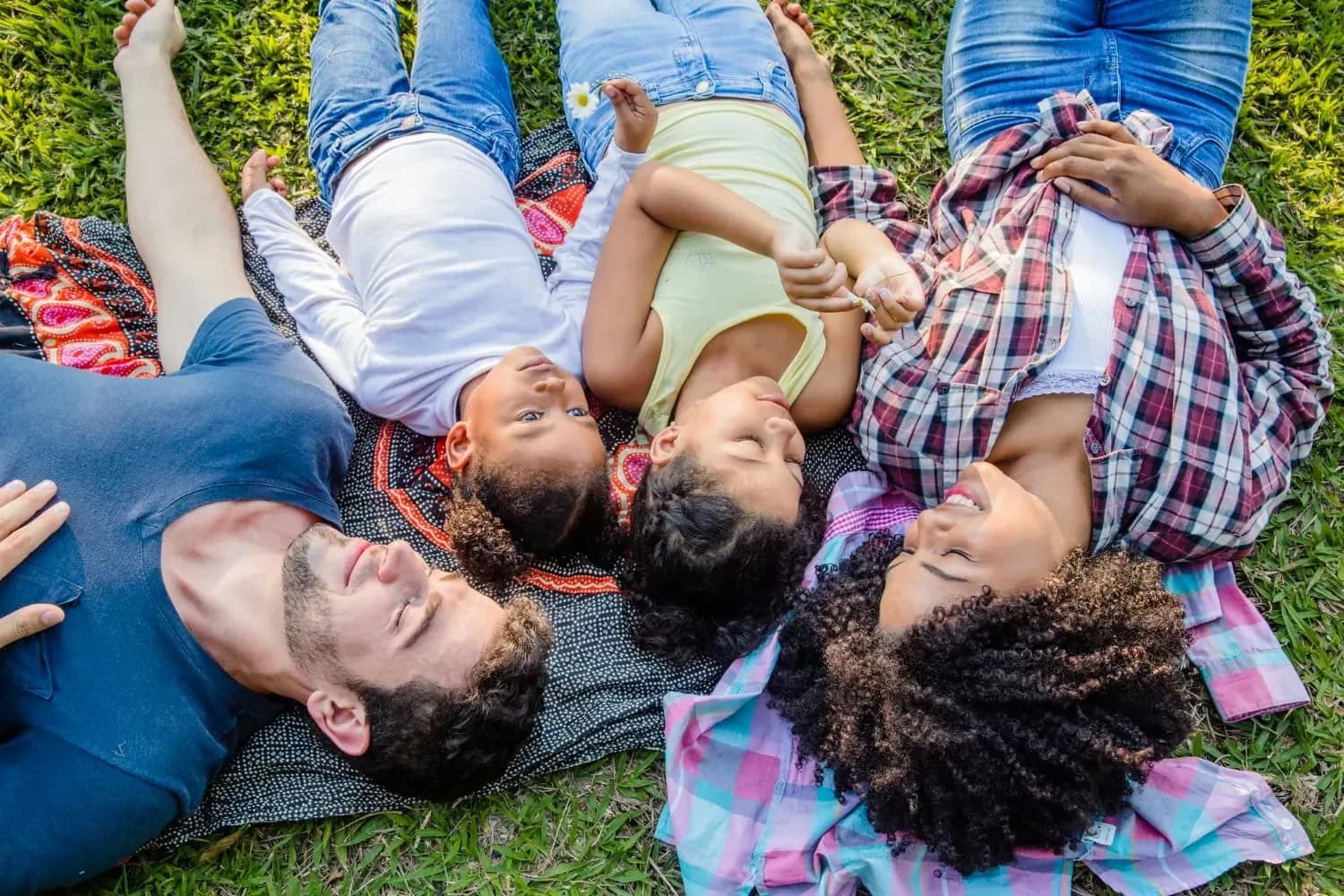 Family enjoying outdoor time on grass at Neola Dental in Minneola, FL.