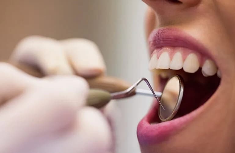 Neola Dental dentist gently examining a patient in a comfortable treatment chair